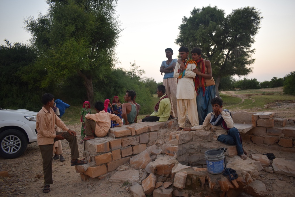 The villagers watch as we drink some fresh water from the wells in Mundhari, Jaisalmer, Rajasthan, India