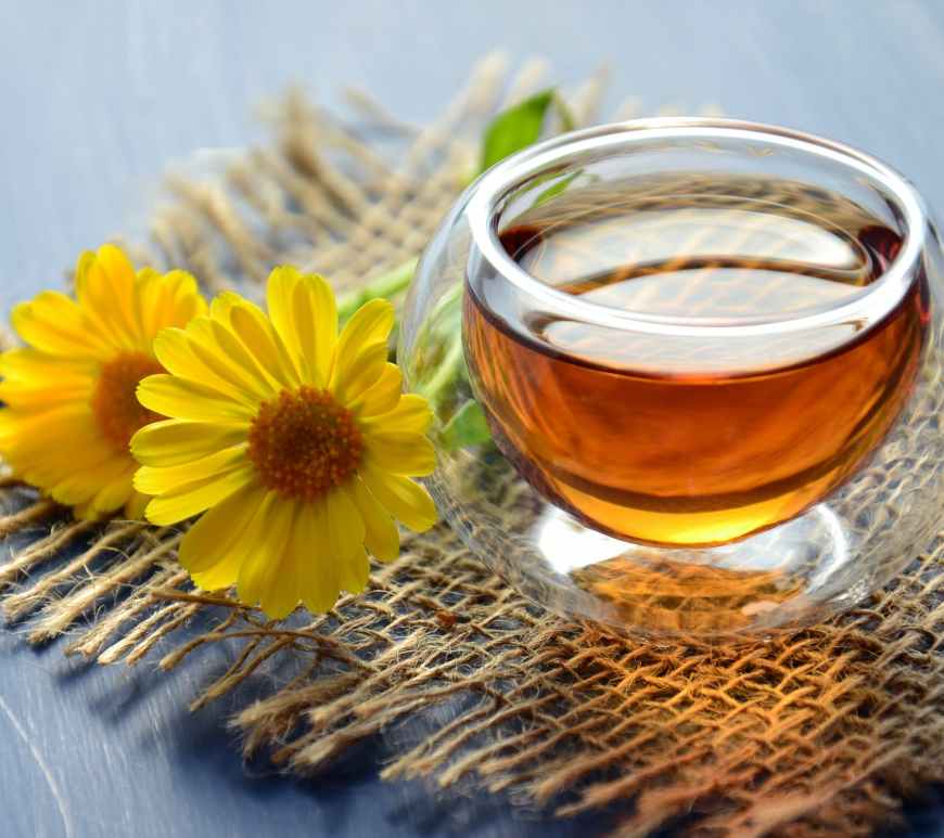 clear glass bowl beside yellow flower
