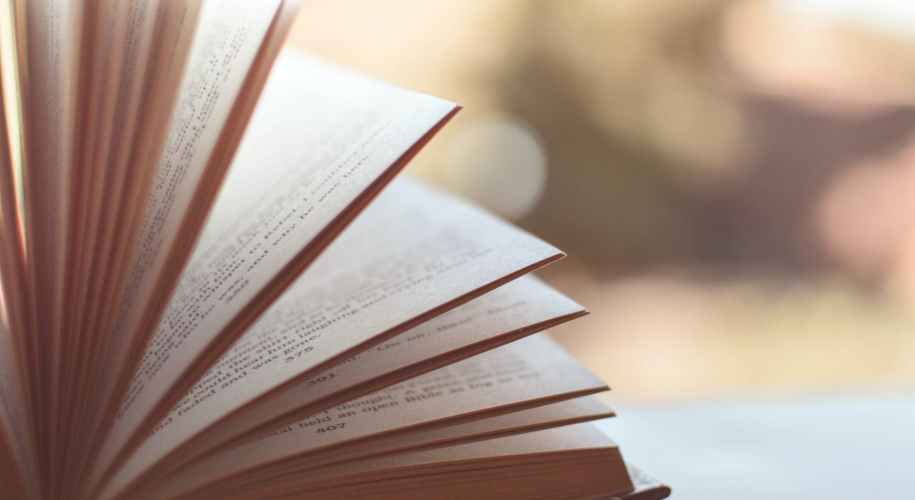 book opened on white surface selective focus photography