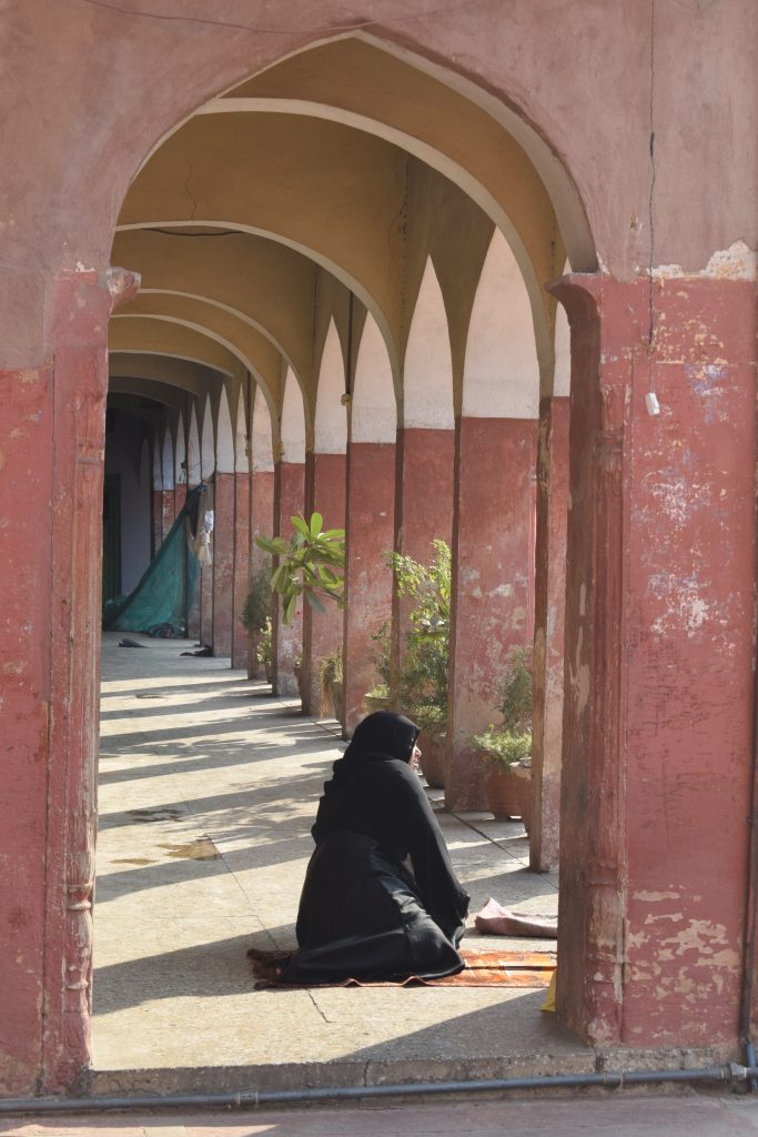 Woman praying inside Fatehpuri Mosque, Old Delhi, India