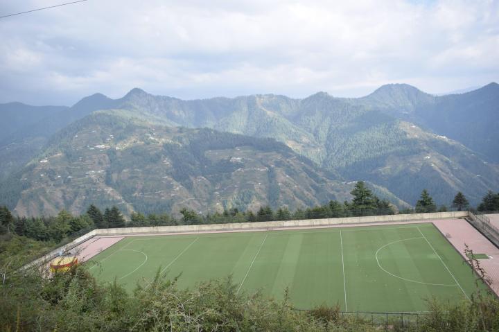 Synthetic truf hockey stadium at the edge of the cliff, Shilaroo village, Himachal Pradesh, India