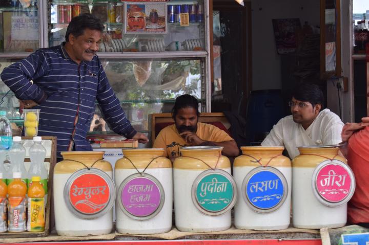 Jars filled with different flavoured waters that the panipuri is dunked in, streets of Pushkar, Rajasthan, India