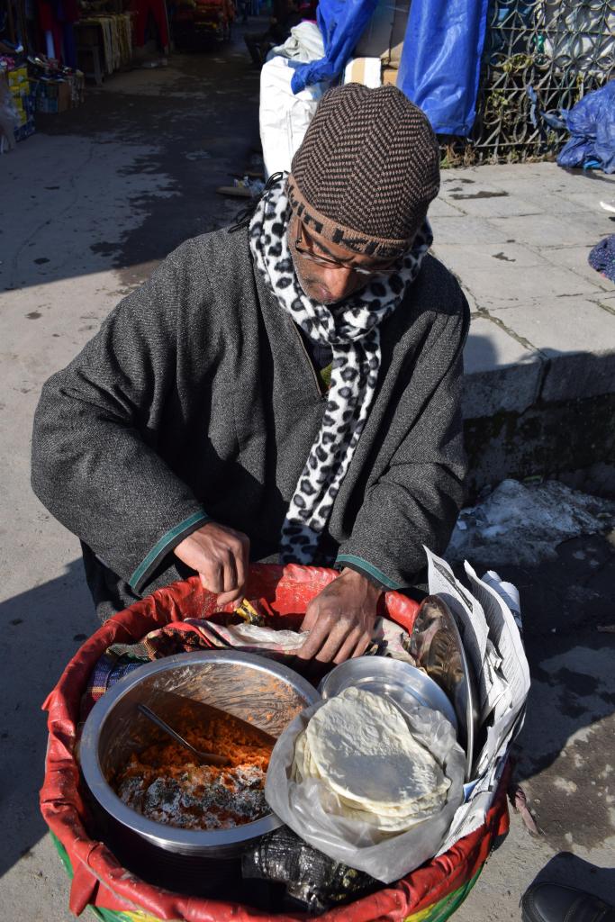 Kruhun Masale, boiled chana rolled in a thin white flour roti and dipped in tomato chutney, Srinagar old market, Kashmir, India
