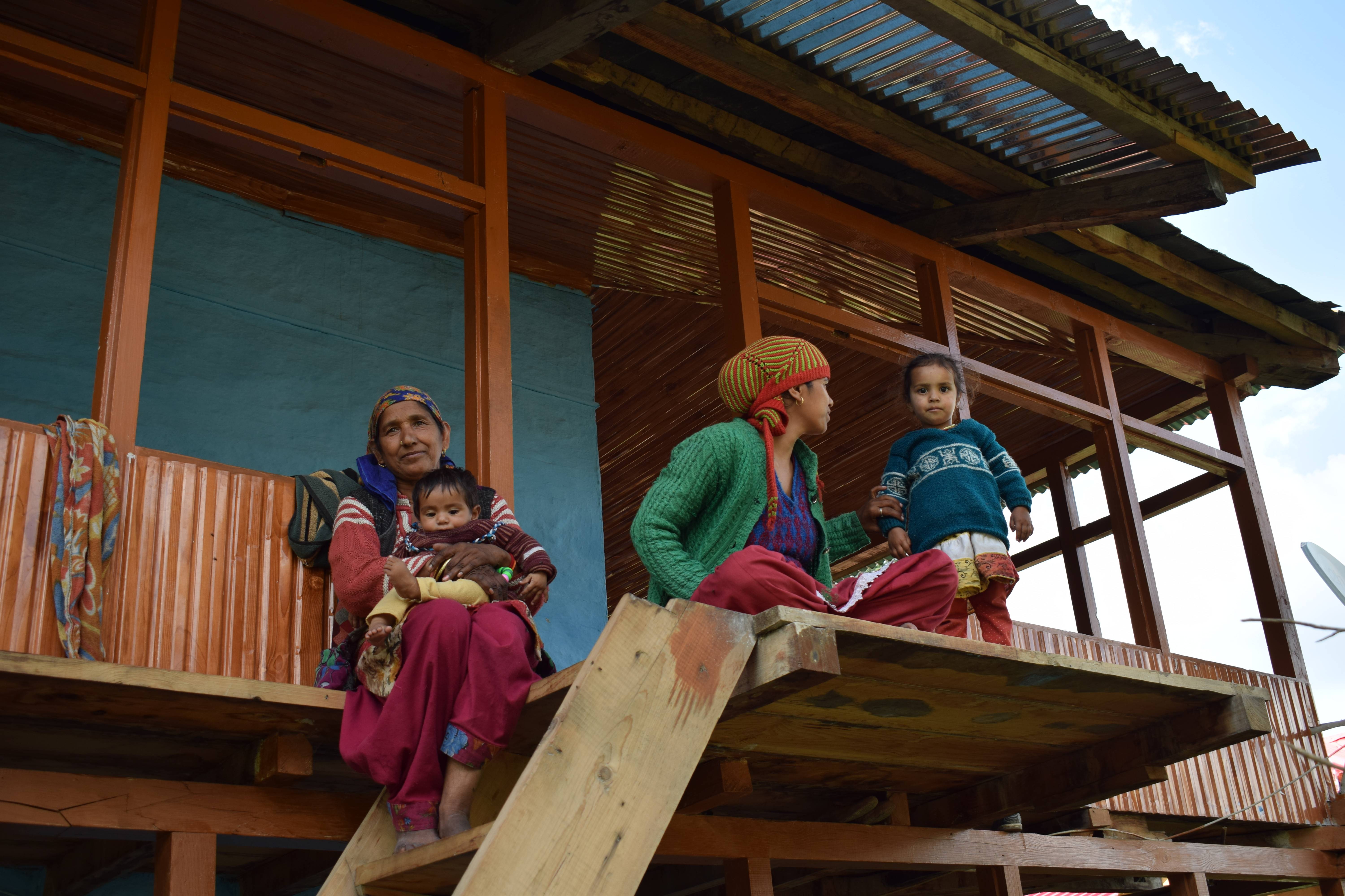 Women and children in their wooden homes, Sarchi, Himachal Pradesh, India 