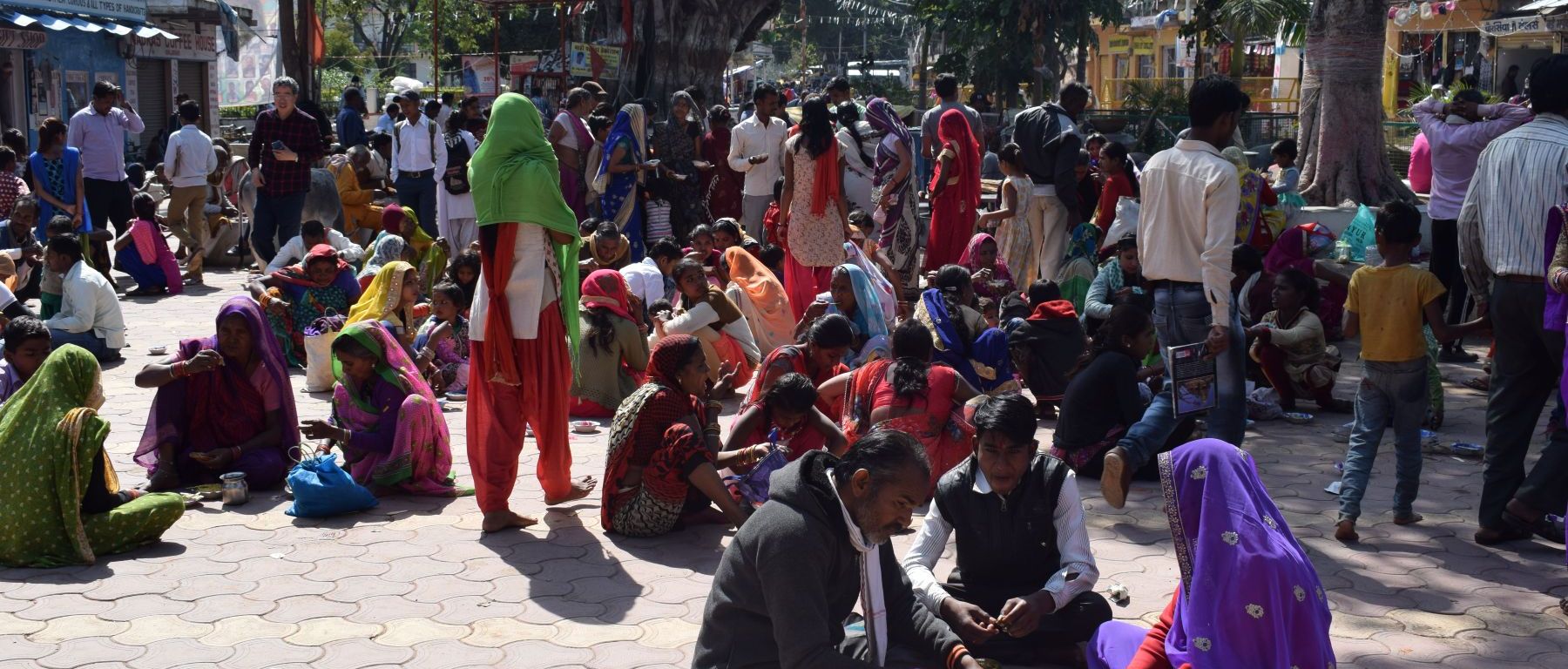 Coming from the villages across Madhya Pradesh, they sit in the market square for lunch, waiting for the living temple of Shiva in Khajuraho to open its doors, India