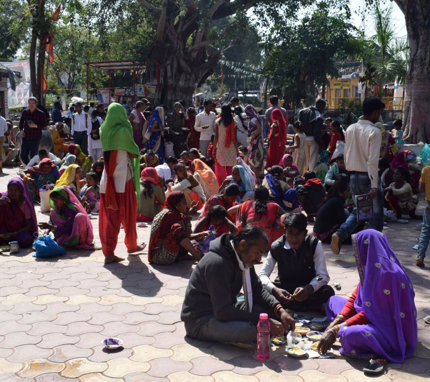 Coming from the villages across Madhya Pradesh, they sit in the market square for lunch, waiting for the living temple of Shiva in Khajuraho to open its doors, India