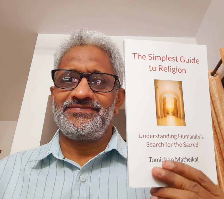 Tomichan Matheikal with his book,The Simplest Guide to Religion